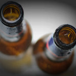 Top View of Empty Beer Bottles on White Background