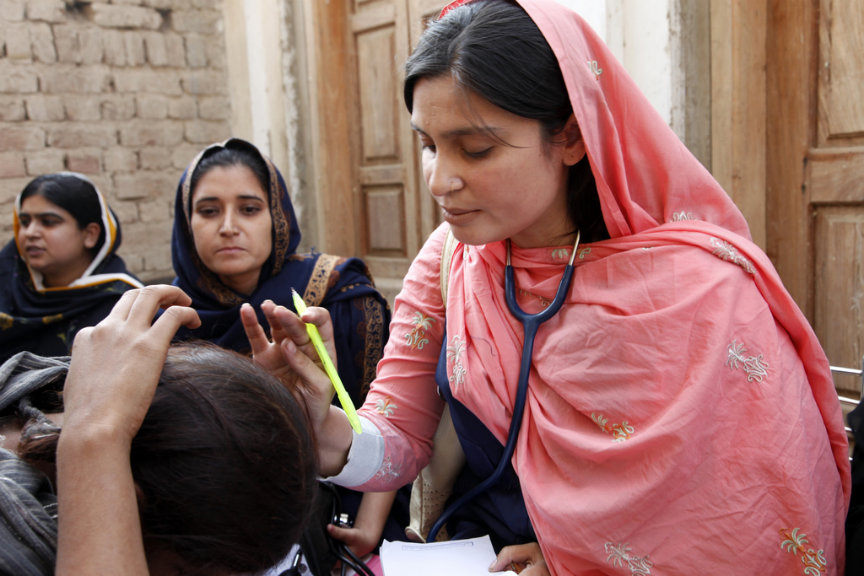 A female doctor with the international medical corps examines a woman patient at a mobile health clinic in pakistan (image by uk department for international development via flickr)